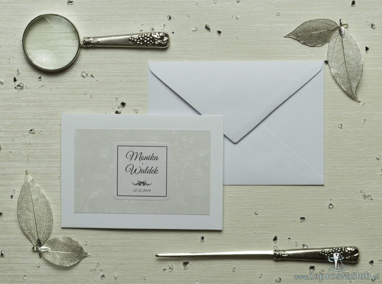 Eleganckie zaproszenia ślubne z cyrkonią oraz jasnym papierem ozdobnym z motywem wytłaczanych serc, na który przyklejony jest motyw tekstowy. ZAP-72-65